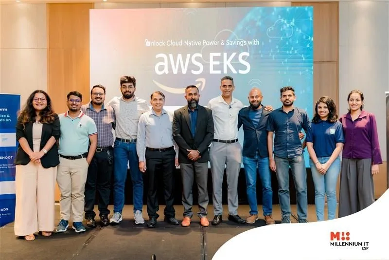 Group photo of attendees at the AWS EKS Workshop in Colombo, standing in front of an AWS EKS banner with the Millennium IT logo