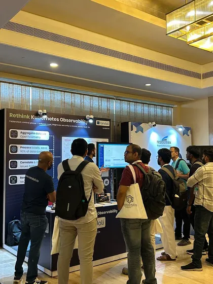 Visitors talking with the Randoli team at the booth at KCD Bengaluru 2025, beside a 'Rethink Kubernetes Observability' banner